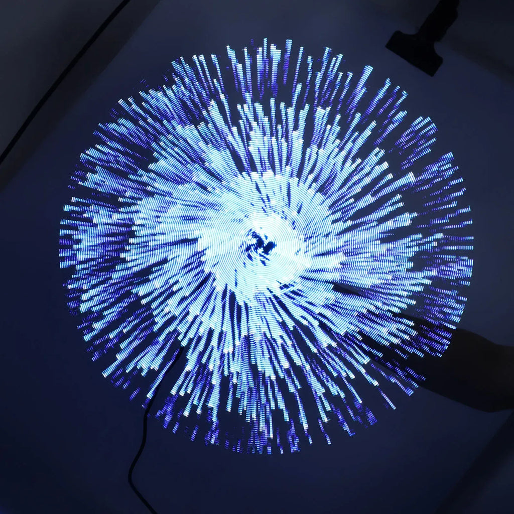 Circular light display with blue and white lights on a dark background