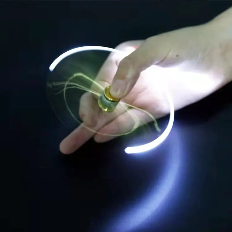 Hand holding a small glowing object against a dark background