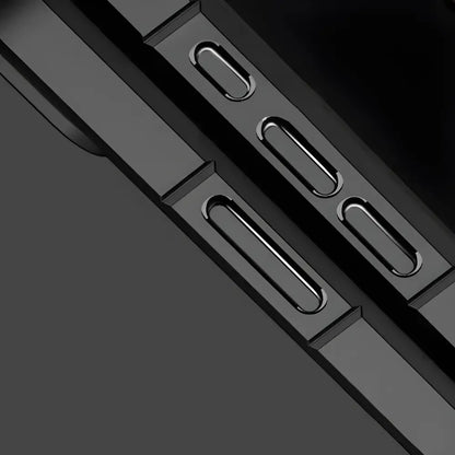 Close-up of a black phone case with cutouts on a dark background