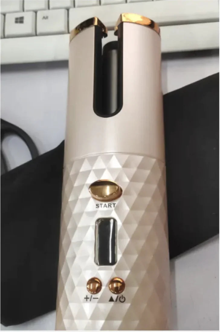 White and gold electronic device with control buttons on a blurred background