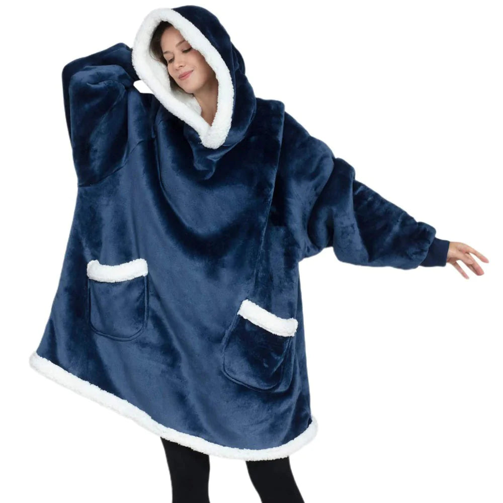 Person wearing a blue fleece poncho with white trim on a white background