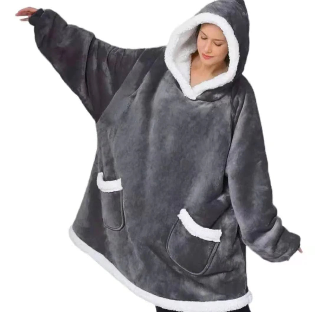 Person wearing a gray shark-shaped hoodie with white accents on a white background