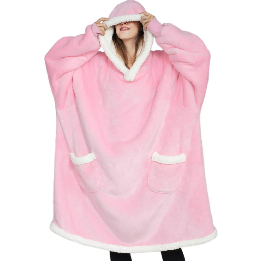 Person wearing a pink hooded blanket with white trim on a white background