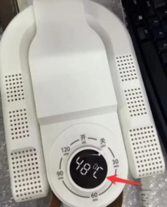 White electronic device with digital display and control buttons on a blurred background