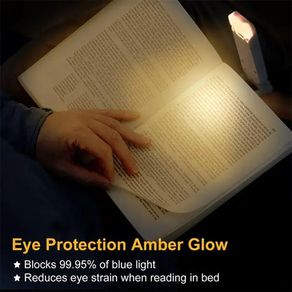 Book being illuminated by a small lamp with text about eye protection and blue light blocking.