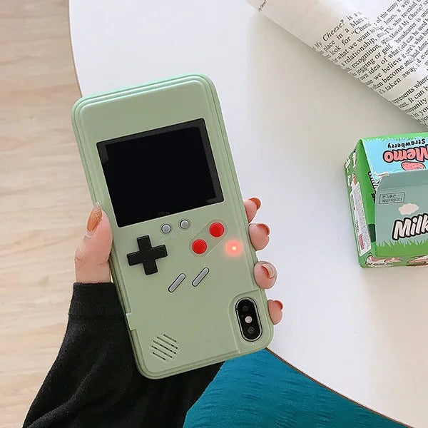 Phone case designed like a retro game console held by a person.