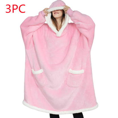 Pink hooded blanket with white trim worn by a person on a white background